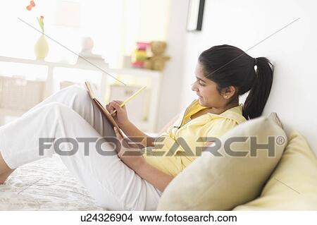 Picture - Girl (12-13) writing. Fotosearch