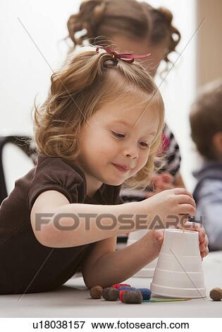 Stock Photo - Girl (2-3) playing in kindergarten. Fotosearch