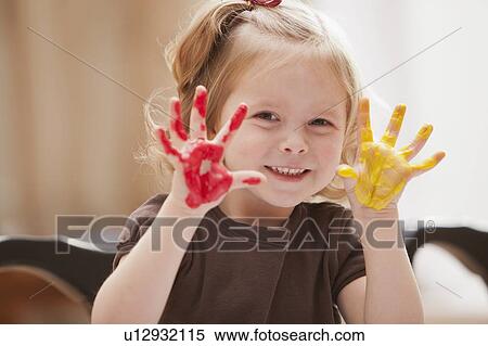 Stock Photography - Girl (2-3) with paint covered hands. Fotosearch