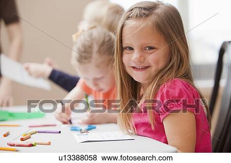 Girl (4-5) looking at camera during art lesson in kindergarten View Large Photo Image Stock Photo - Girl (4-5) looking at camera during art lesson in kindergarten. Fotosearch
