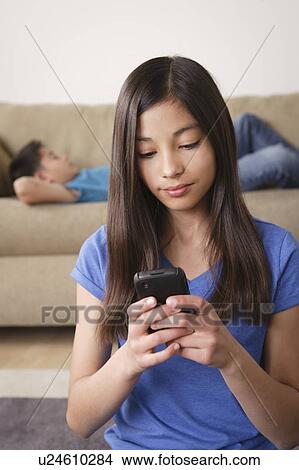Girl using smartphone View Large Photo Image Picture - Girl using smartphone. Fotosearch