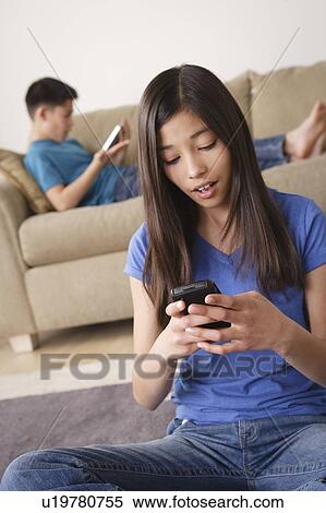 Stock Photography - Girl using smartphone. Fotosearch
