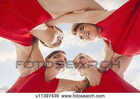 Stock Photo - Girls (12-13) in huddle. Fotosearch