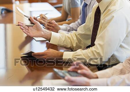 Hands of business people at business meeting View Large Photo Image Stock Image - Hands of business people at business meeting. Fotosearch