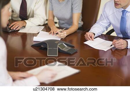 Stock Photo - Hands of business people at business meeting. Fotosearch