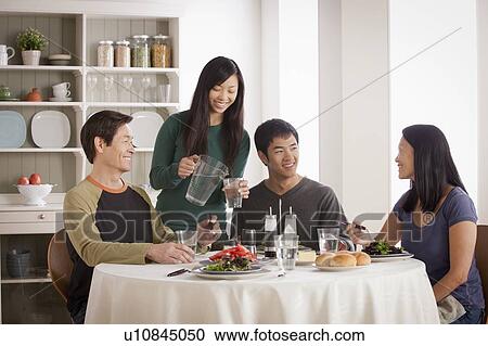 Happy family having meal together View Large Photo Image Stock Image - Happy family having meal together. Fotosearch