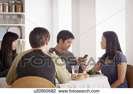 Happy family having meal together View Large Photo Image Stock Image - Happy family having meal together. Fotosearch