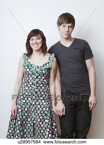 Happy young couple posing in studio View Large Photo Image Picture - Happy young couple posing in studio. Fotosearch