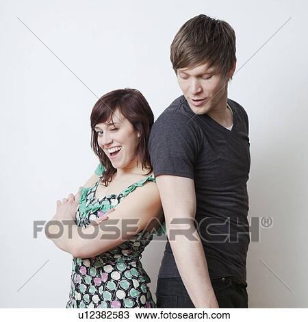 Stock Image - Happy young couple posing in studio. Fotosearch
