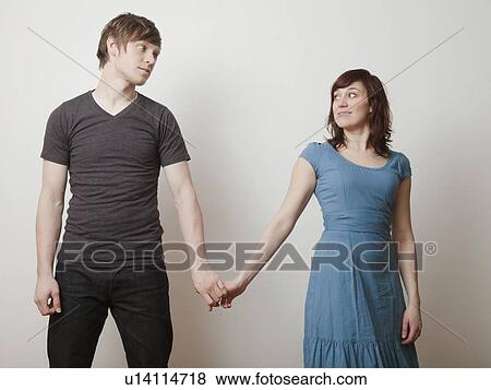 Happy young couple posing in studio View Large Photo Image Stock Photo - Happy young couple posing in studio. Fotosearch