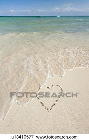 Heart drawing in sand on beach View Large Photo Image Stock Photo - Heart drawing in sand on beach. Fotosearch