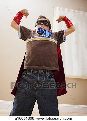 Stock Photograph - Low angle view of boy (6-7) in fancy dress costume. Fotosearch
