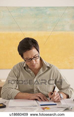 Man doing paperwork View Large Photo Image Stock Photo - Man doing paperwork. Fotosearch