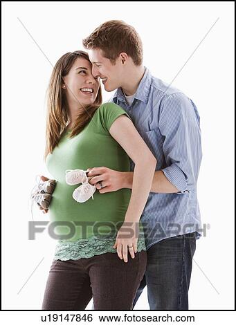 Man embracing pregnant woman, studio shot View Large Photo Image Stock Photograph - Man embracing pregnant woman, studio shot. Fotosearch