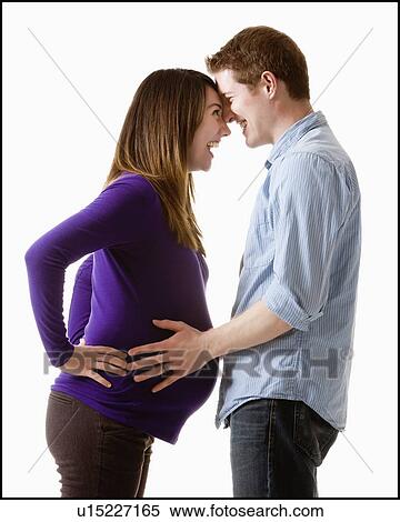 Man embracing pregnant woman, studio shot View Large Photo Image Stock Photography - Man embracing pregnant woman, studio shot. Fotosearch
