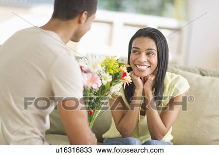 Man giving bouquet of flowers to woman View Large Photo Image Stock Image - Man giving bouquet of flowers to woman. Fotosearch