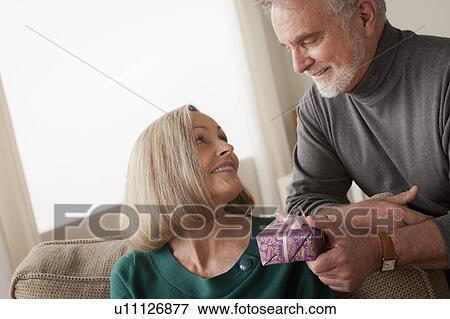 Man giving woman gift View Large Photo Image Stock Photo - Man giving woman gift. Fotosearch