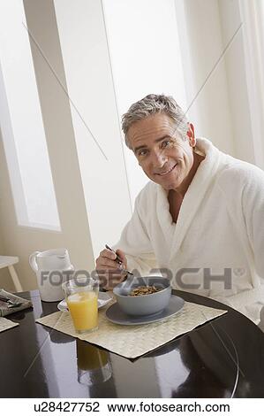 Man having cereal for breakfast View Large Photo Image Stock Image - Man having cereal for breakfast. Fotosearch