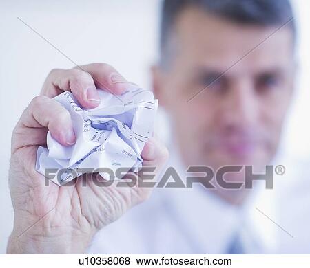 Man holding crumpled paper ball View Large Photo Image Stock Photo - Man holding crumpled paper ball. Fotosearch
