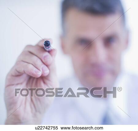 Man holding felt tip pen View Large Photo Image Stock Photography - Man holding felt tip pen. Fotosearch