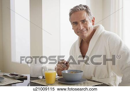 Man in bathrobe having cereal for breakfast View Large Photo Image Stock Photography - Man in bathrobe having cereal for breakfast. Fotosearch
