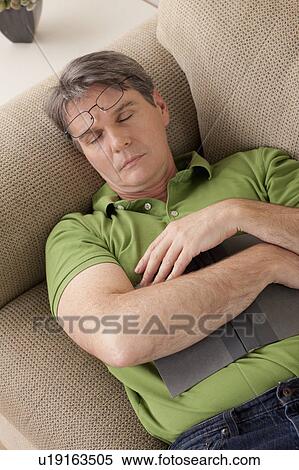 Man napping on couch View Large Photo Image Stock Photography - Man napping on couch. Fotosearch