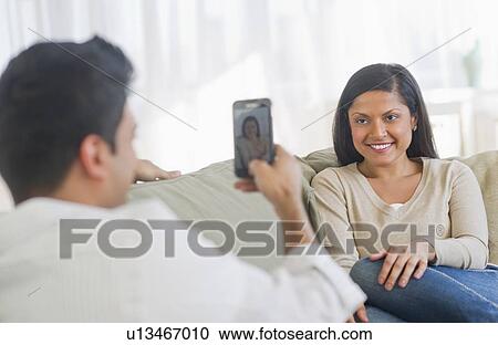 Man photographing woman with smart phone View Large Photo Image Stock Image - Man photographing woman with smart phone. Fotosearch