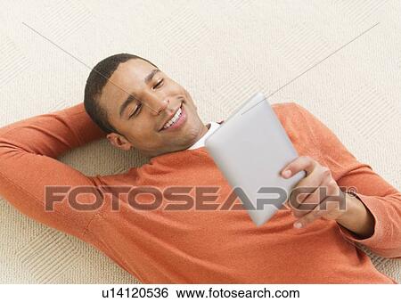 Stock Photograph - Man reading e-book. Fotosearch