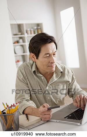 Man shopping online from home View Large Photo Image Stock Image - Man shopping online from home. Fotosearch