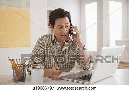 Stock Photo - Man shopping online from home. Fotosearch