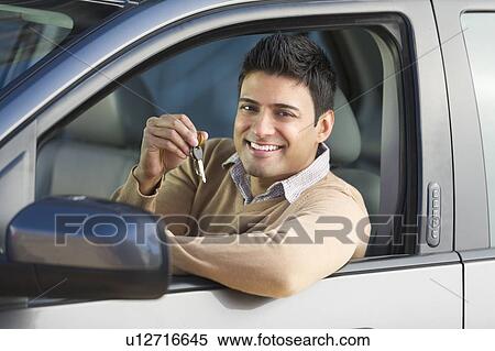 Man sitting in his new car View Large Photo Image Stock Photography - Man sitting in his new car. Fotosearch