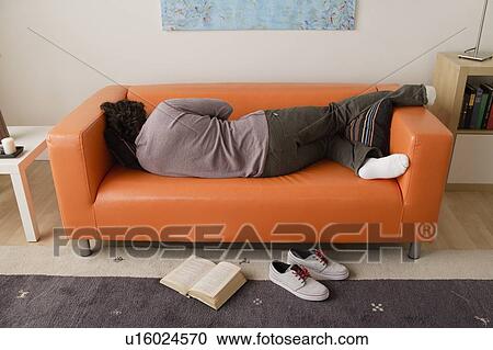 Man sleeping on sofa View Large Photo Image Stock Image - Man sleeping on sofa. Fotosearch