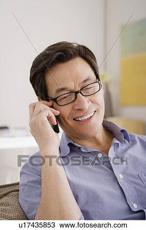 Stock Image - Man talking on phone. Fotosearch