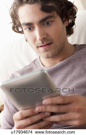 Picture - Man using digital tablet. Fotosearch