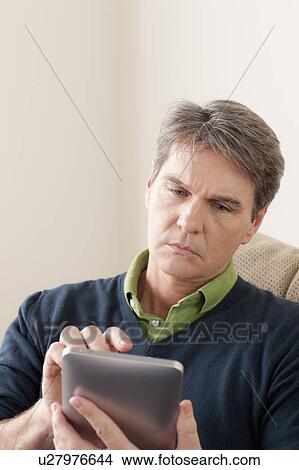 Picture - Man using digital tablet. Fotosearch