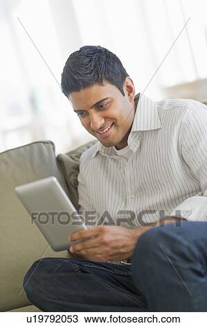 Stock Image - Man using digital tablet. Fotosearch