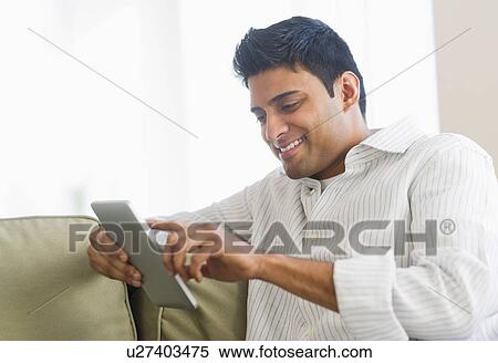 Stock Photography - Man using digital tablet. Fotosearch