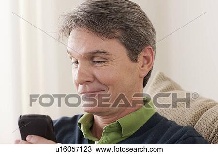 Stock Image - Man using phone. Fotosearch