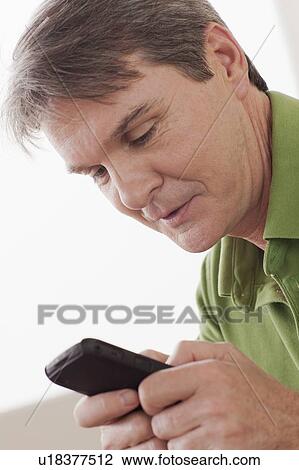 Stock Image - Man using phone. Fotosearch