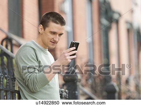 Man using smart phone on street View Large Photo Image Stock Image - Man using smart phone on street. Fotosearch