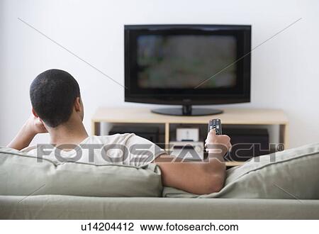 Man watching tv at home View Large Photo Image Stock Image - Man watching tv at home. Fotosearch