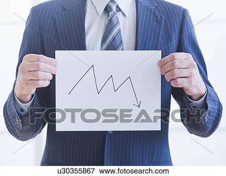 Stock Photo - Man wearing suit holding chart. Fotosearch