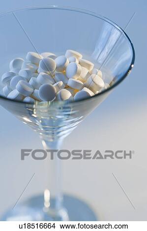Martini glass filled with pills, studio shot View Large Photo Image Picture - Martini glass filled with pills, studio shot. Fotosearch