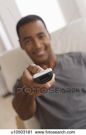 Mature man holding remote control, focus on foreground View Large Photo Image Stock Image - Mature man holding remote control, focus on foreground. Fotosearch
