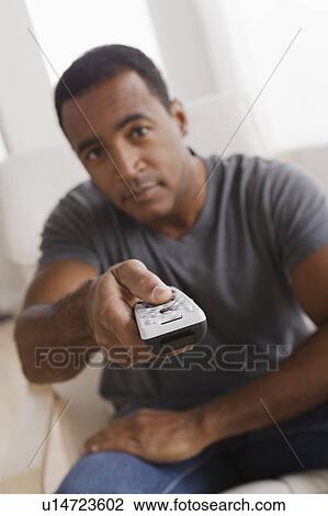 Mature man holding remote control View Large Photo Image Stock Image - Mature man holding remote control. Fotosearch
