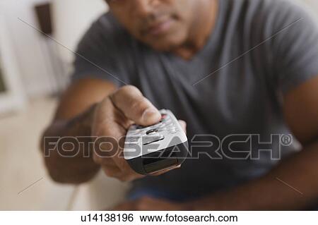 Mature man holding remote control, focus on foreground View Large Photo Image Stock Photograph - Mature man holding remote control, focus on foreground. Fotosearch