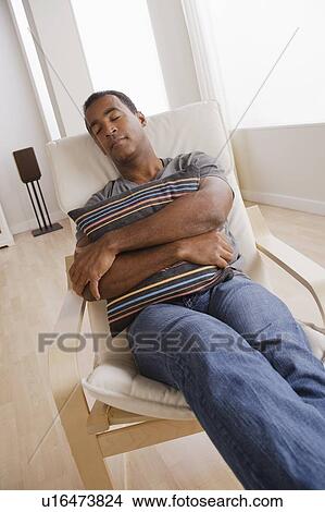 Mature man sleeping on armchair View Large Photo Image Picture - Mature man sleeping on armchair. Fotosearch