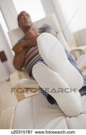 Mature man sleeping on armchair View Large Photo Image Stock Photo - Mature man sleeping on armchair. Fotosearch