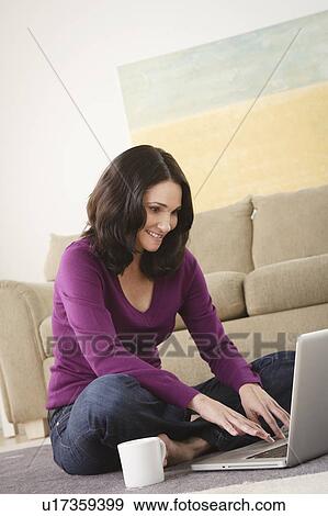 Mature woman using laptop at home View Large Photo Image Stock Photo - Mature woman using laptop at home. Fotosearch
