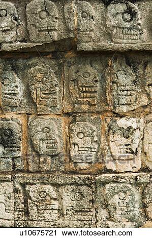 Stock Image - Mayan carvings representing human skulls. Fotosearch